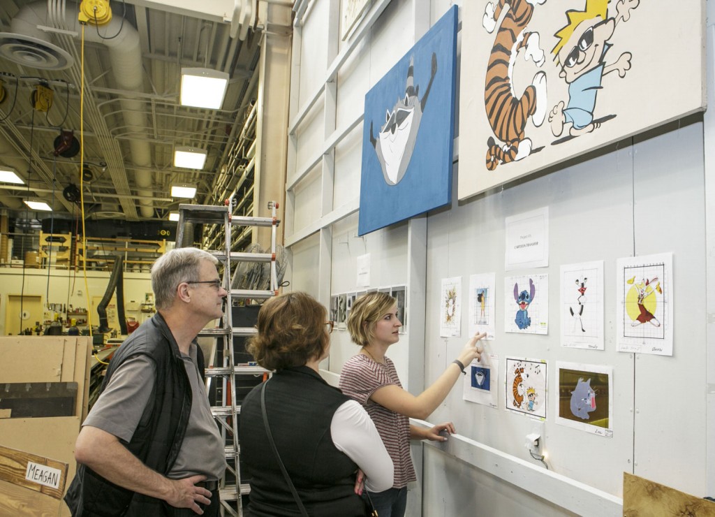 Alice describes the enlargement process for cartoon transfer for her scenic painting class to parents Teresa and Byron Pollitt in 2015. (David Sprague/USC Photo)