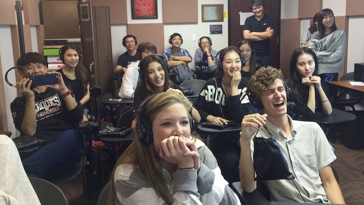 Image of students sharing a laugh during a voice-over demonstration.