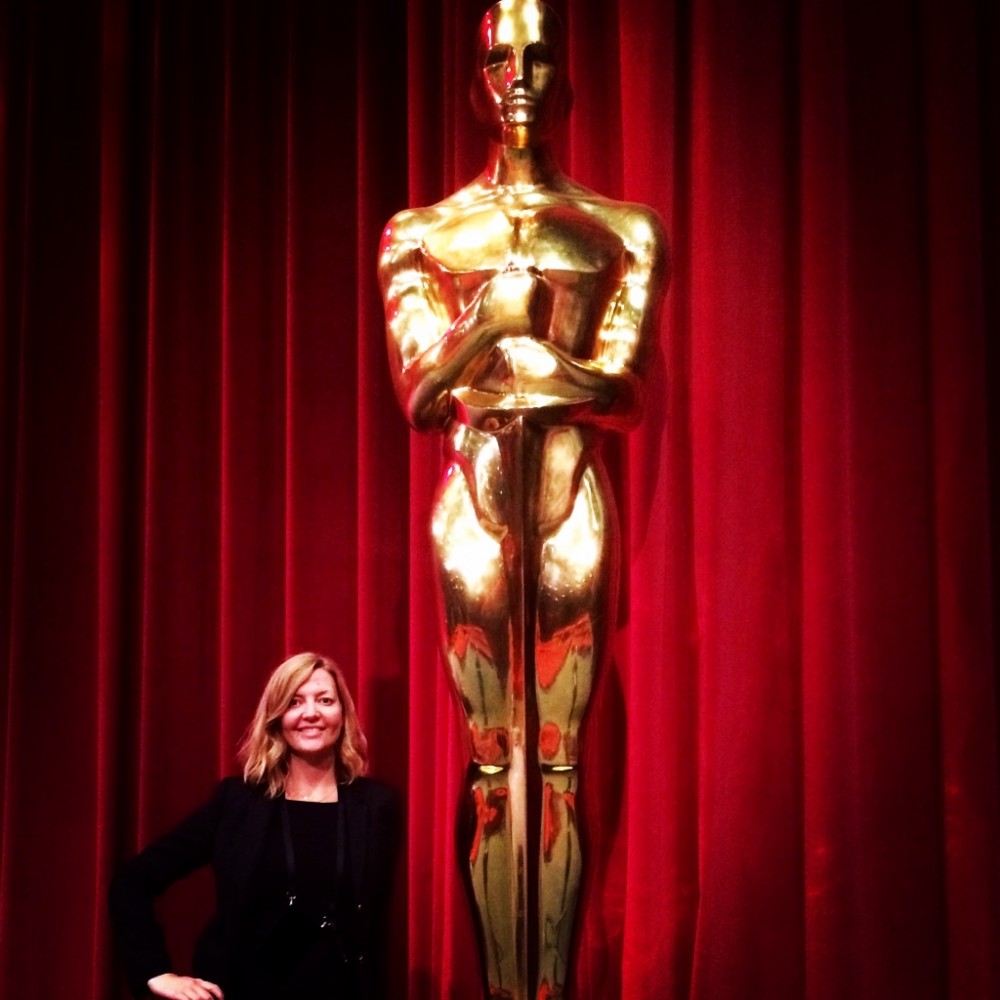 Vanessa J. Noon in front of an Oscars statue.