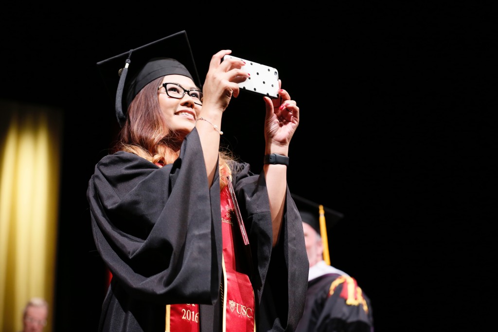Jennifer Caspellan Franco snaps a memory during the 2016 undergraduate commencement ceremony. Photo by Ryan Miller/Capture Imaging.