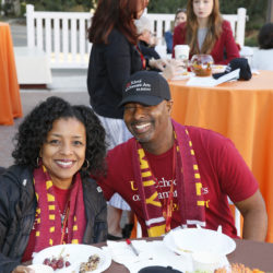 Parents at breakfast table in USC spirit wear