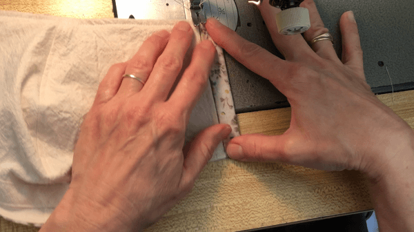 Hands at sewing maching sewing mask