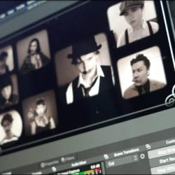 Photo of a laptop with actors' faces from a virtual production.