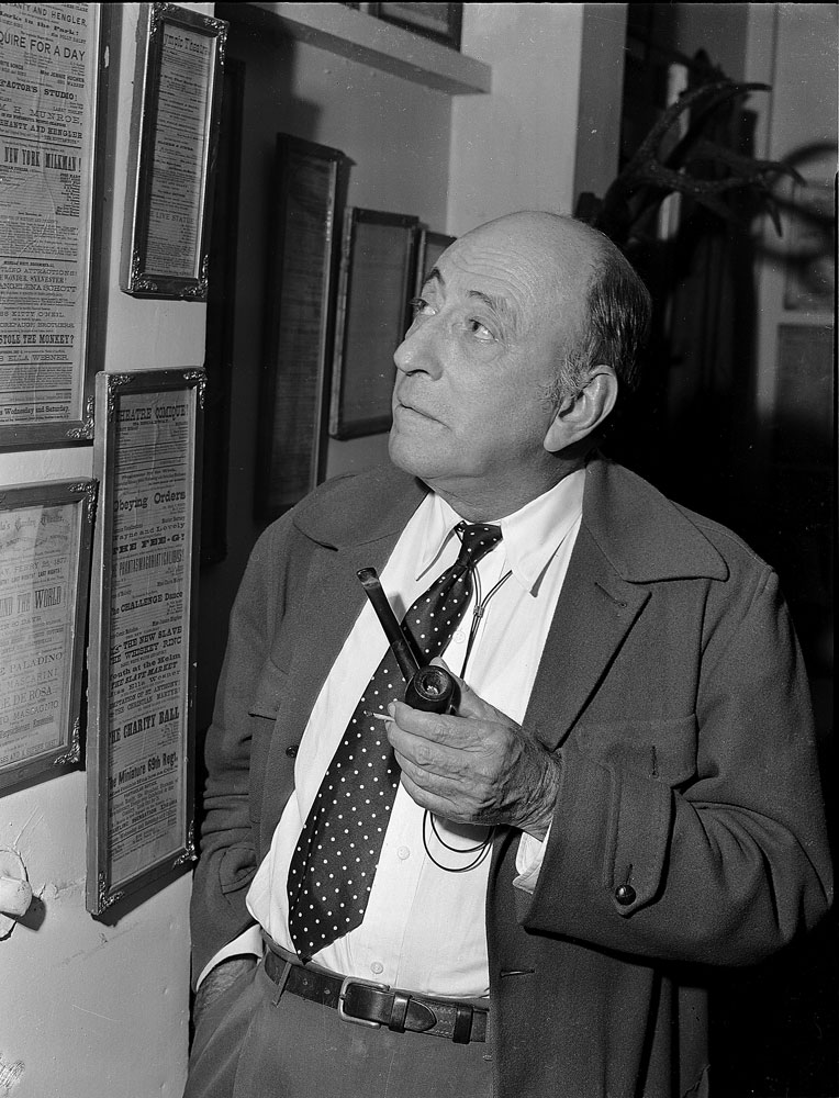 William C. DeMille looking at a wall art.