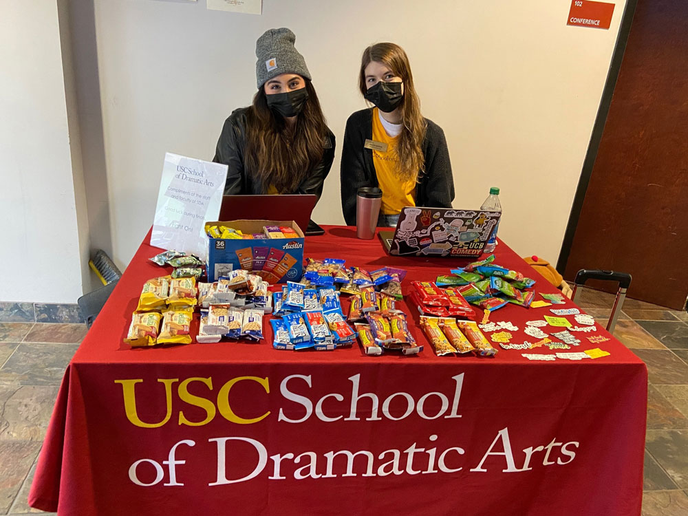 Student Ambassadors Mikaela Villalpando, left, and Maddi Moran welcome guests at a table during the opening of the Office of EDI space.