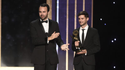 Madigan Stehly and Ben Green accept an Emmy Award on stage