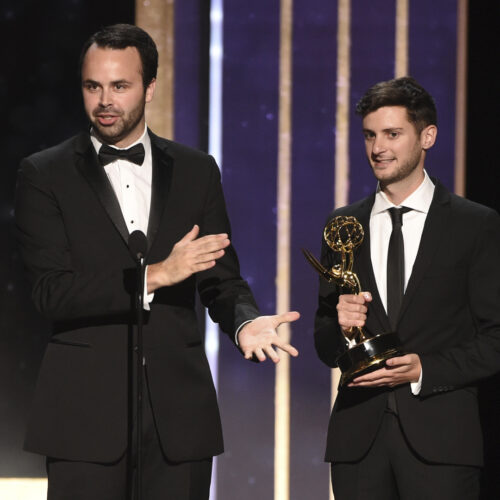 Madigan Stehly and Ben Green accept an Emmy Award on stage