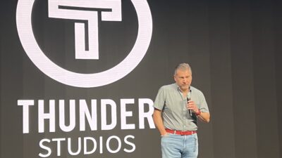 Rodric David stands on stage in front of a Thunder Studios logo.