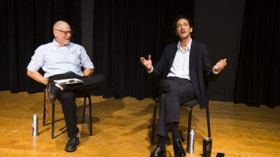 David Warshofsky and Adrien Brody sit on stage and chat.