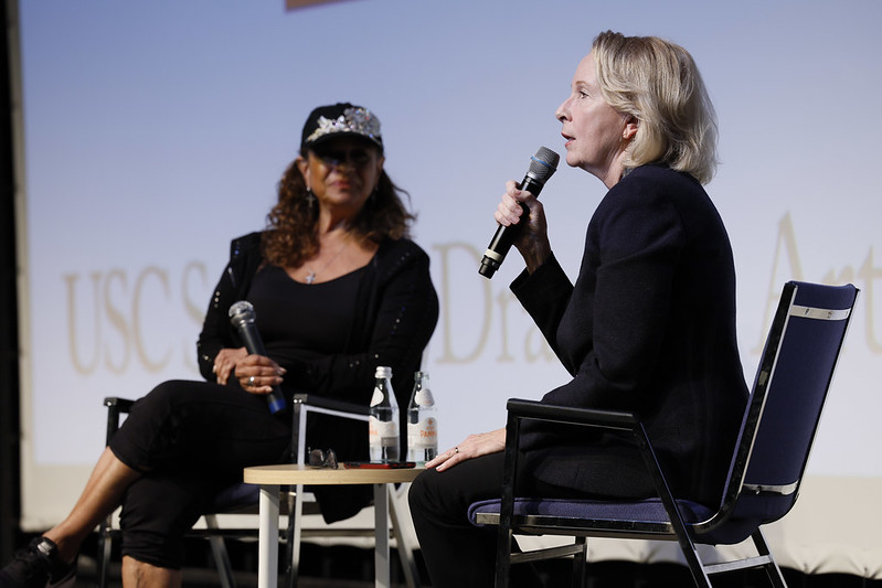 Debbie Allen and Kate Burton sit side by side holding microphones and talking.