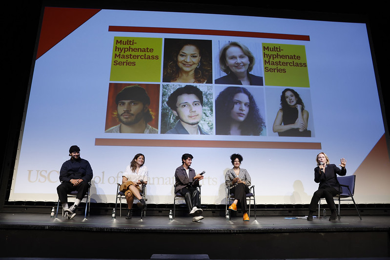 Scott Felix, Tessa Hope Slovis, Neal Mulani, Gabriela Ortega, and Kate Burton sit on chairs holding microphones in front of a large projection of their images.