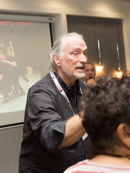 Brent Blair gestures to a group of workshop attendees in Israel.