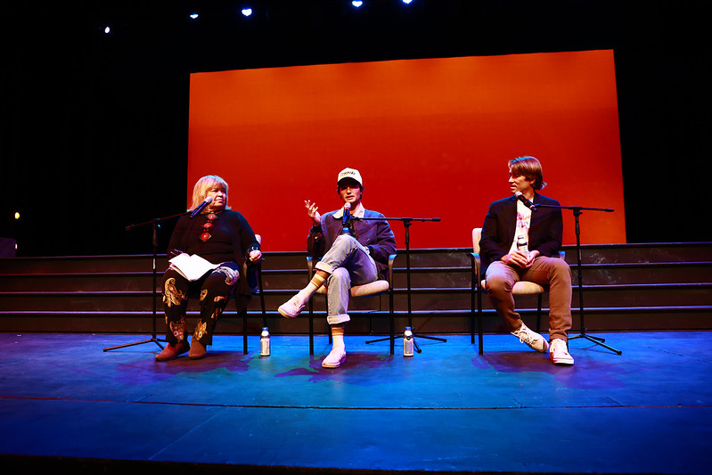Michele Shay, Chase Stokes and Jonas Pate sitting on chairs on stage discussing