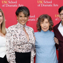 Alexandra Billings poses with Emily Roxworthy and two others in front of an SDA cardinal and gold banner