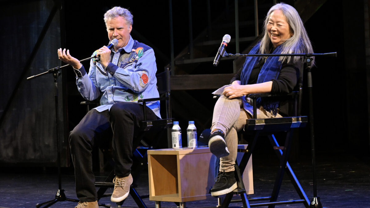 Will Ferrell sits on stage next to Professor Natsuko Ohama, chatting amiably.