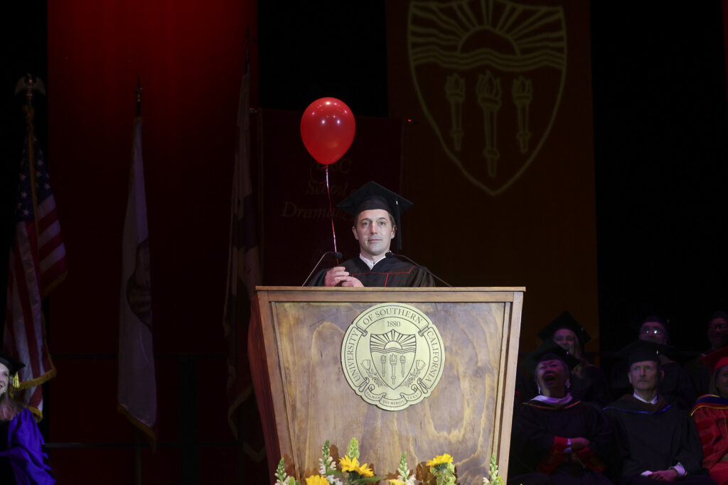 Beck Bennett holding a balloon. 