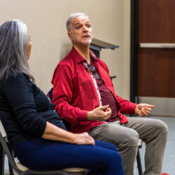 Professor Natsuko Ohama and voice coach Louis Colaianni sit in chairs in disucssion.