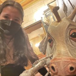 Karlie Teruya poses with a prop cow while stage managing Into the Woods on Broadway.