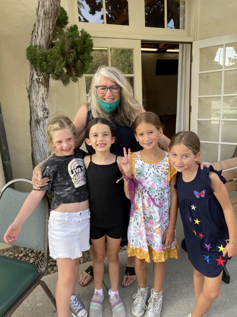 Deirdre Andrews poses with arms around four child actors at the La Jolla Young Actors Workshop.