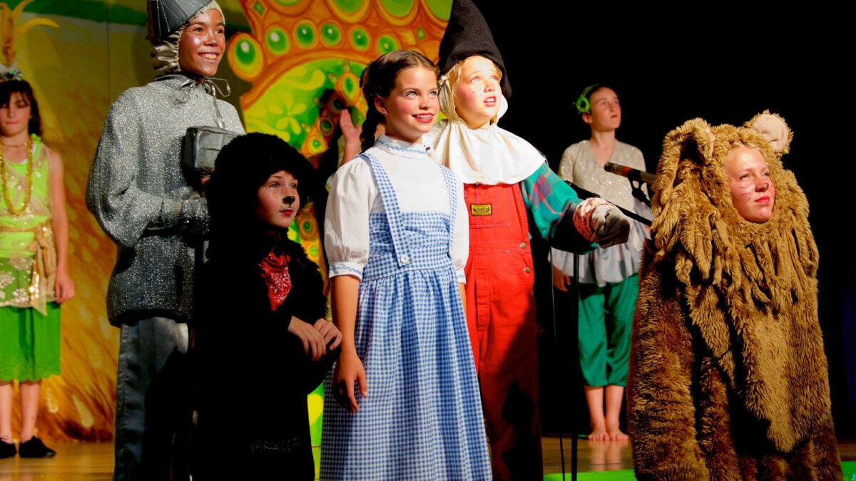 A cast of young actors performs a scene from the Wizard of Oz.