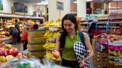 A student shops for groceries at Trader Joe's.