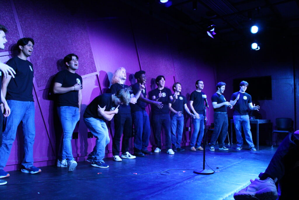 Members of The Trojan Men perform a capella songs onstage at the Stop Gap Theatre.