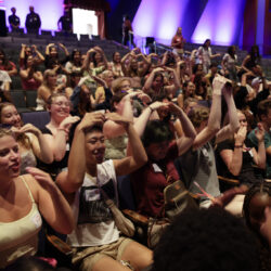 A crowd of students celebrating and making gestures at the 2024 New Student Welcome.