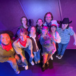 Members of the Merry Men pose against a purple background.