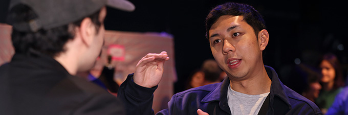 creative leadership minor_680x225 One student instructs another, gesturing with his hands.