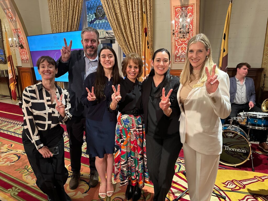 USC President Carol Folt (center), USC School of Dramatic Arts Dean Emily Roxworthy (right) and loved ones celebrate Professor Heinrich's award at the Academic Honors Convocation.