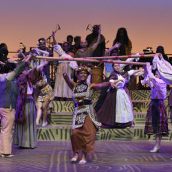 Students and community members performing onstage in