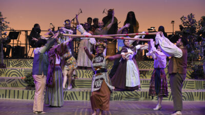 Students and community members performing onstage in 