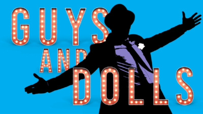 Guys and Dolls written in lights with an image of a man with his arms outstretched