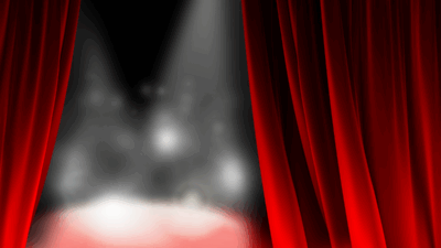 Stage lights on a blurry stage with red curtains opening