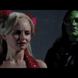 Photo of two student actors dressed as Elphaba and Glinda for the halftime spectacular.