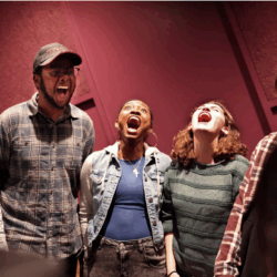 Students in a class room with mouths open wide like they are cheering