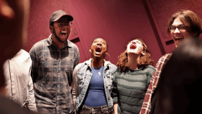 Students in a class room with mouths open wide like they are cheering